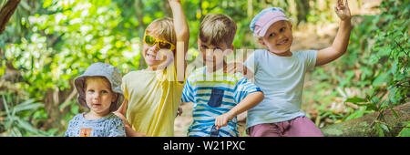 Children rest during a hike in the woods BANNER, LONG FORMAT Stock Photo