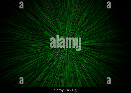 natural lens zoom explosion radial blurred green particles on black background with selective focus. Stock Photo