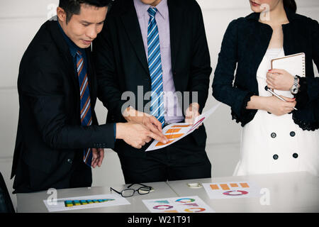 businessmen working and point on graph financial diagram and analysis documents on office table Stock Photo