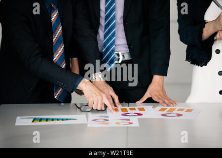 businessmen working and point on graph financial diagram and analysis documents on office table Stock Photo