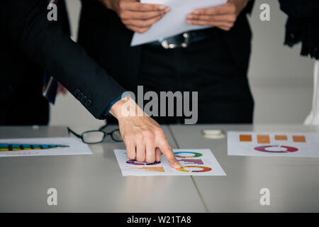 businessmen working and point on graph financial diagram and analysis documents on office table Stock Photo