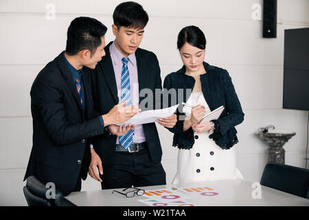 businessmen working and point on graph financial diagram and analysis documents on office table Stock Photo