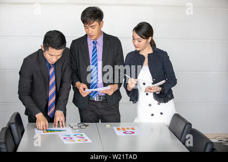 businessmen working and point on graph financial diagram and analysis documents on office table Stock Photo