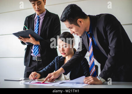 businessmen working and point on graph financial diagram and analysis documents on office table Stock Photo