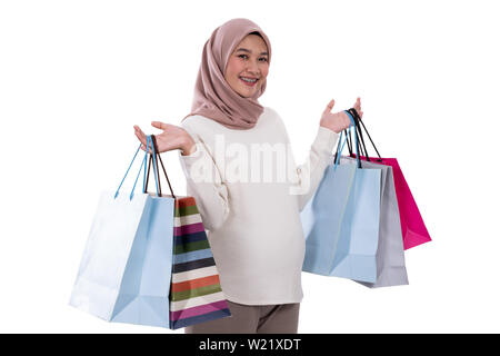 woman pregnant show lots of shopping bags after buying in an isolated background Stock Photo