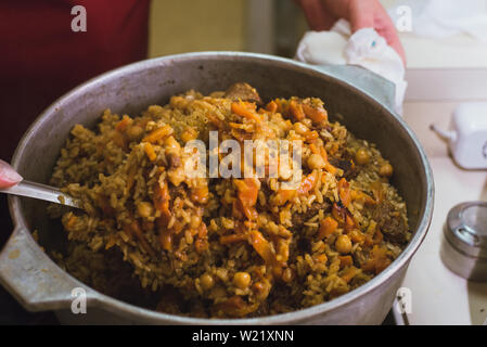 Pieces of raw lamb fat dumba are fried in a black cauldron, cooking food  Stock Photo - Alamy