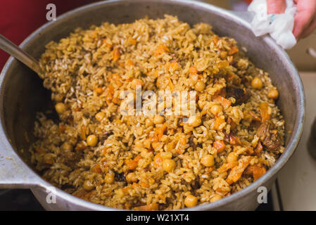 Pieces of raw lamb fat dumba are fried in a black cauldron, cooking food  Stock Photo - Alamy