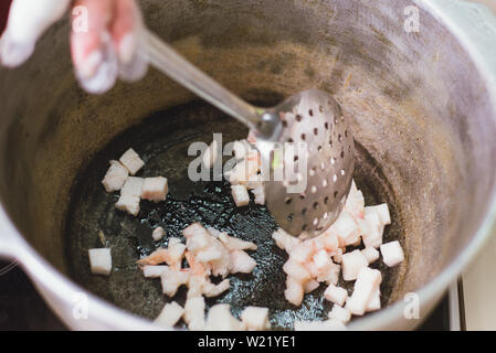 Pieces of raw lamb fat dumba are fried in a black cauldron, cooking food  Stock Photo - Alamy