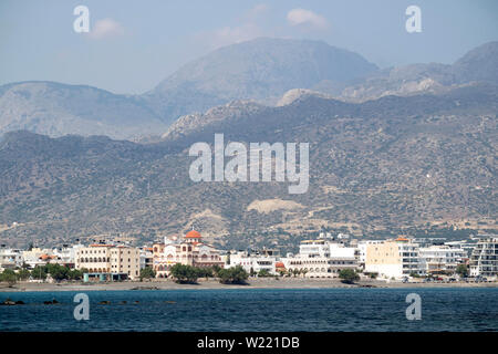 Ierapetra, Crete, Greece. June 2019. The southern coastal town of Ierapetra and the church of Agia Fotini with a mountain backdrop Stock Photo