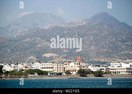 Ierapetra, Crete, Greece. June 2019. The southern coastal town of Ierapetra and the church of Agia Fotini with a mountain backdrop Stock Photo