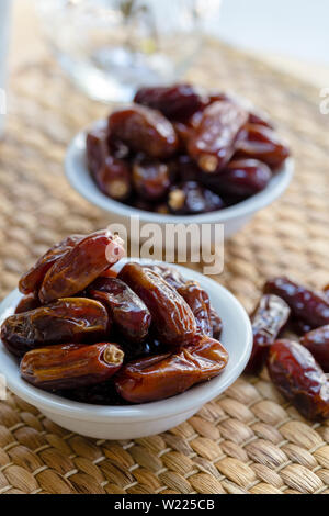 Fresh red dates (hurma) in bowl Stock Photo