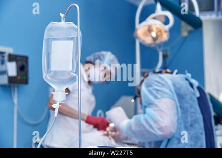 Dropper on a blurred background surgery at the dental clinic. Stock Photo