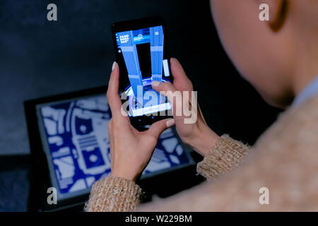 Woman using smartphone with architecture augmented reality app Stock Photo