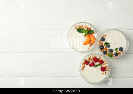 Flat lay composition with yogurt desserts and ingredients on white ...
