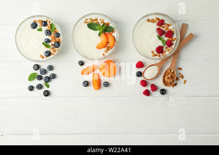 Flat lay composition with yogurt desserts and ingredients on white ...