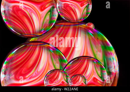 Soap bubble with Colorful liquid paints mixed together creating pattern.rainbow colors on black background. vector soap bubble illustration.Vector ill Stock Photo
