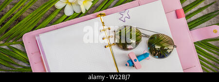 Notepad and stationery on wooden background. Planner for business and study. Fans of stationery. Travel planning notebook. Travel concept BANNER, LONG Stock Photo