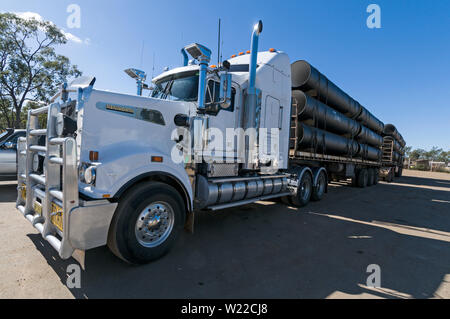 A parked Road Train with its load of drinking water pipes at a lorry park at Injune, a small town in the outback of  Queensland, Australia Stock Photo