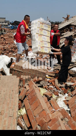Liaoning, Liaoning, China. 5th July, 2019. Liaoning, China - July 4 2019: A tornado hit more than half of the city of kaiyuan, liaoning province, on July 3, 2019.Six people were killed and more than 190 injured.On July 4, more than 20 volunteers helped pick up toilet paper at a private toilet paper factory to minimize losses. Credit: SIPA Asia/ZUMA Wire/Alamy Live News Stock Photo