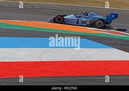 MAGNY-COURS, FRANCE, June 29, 2019 : French flag and F3 racing car. French Historic Grand Prix takes place on Magny-Cours race track every two years. Stock Photo