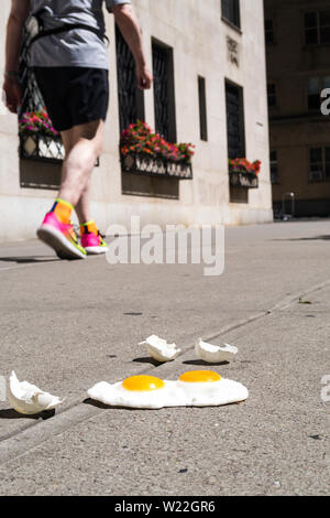 The expression 'it's hot enough to fry eggs on a sidewalk' is used during a heatwave in New York City, USA Stock Photo