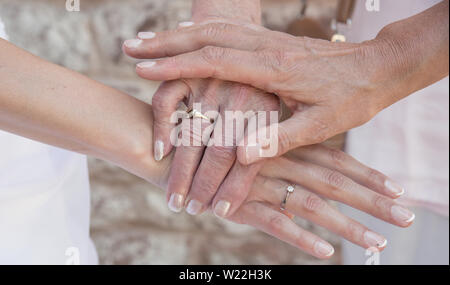 three generation hands granny mother and daughter Stock Photo