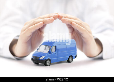 Transport blue van car protected by hands Stock Photo