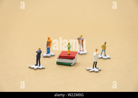 little kids Miniature people standing on books using as background Education concept and Learning concept with copy space and white space. Stock Photo