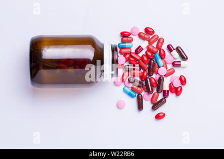 Pills pouring out of the brown bottle,top view Stock Photo