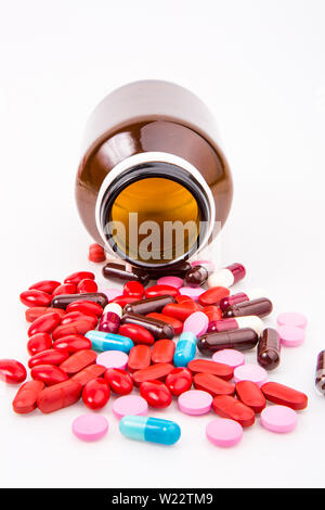 Pills spilling out from a bottle Stock Photo