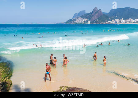 Rio de Janeiro, Brazil - September 23, 2018: landscape view of arpoador and ipanema beach with beach goers swimming Stock Photo