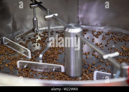 Freshly roasted coffee beans in a coffee roaster Stock Photo