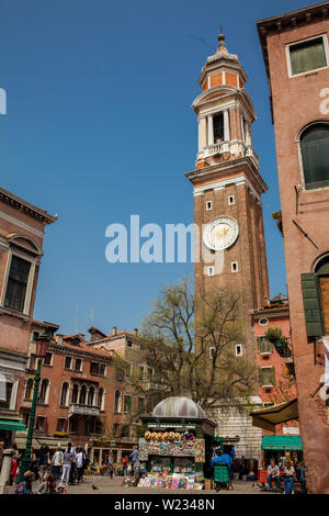 VENICE, ITALY - APRIL, 2018: Tourists and locals walking around the beautiful streets of Venice in a sunny early spring day Stock Photo