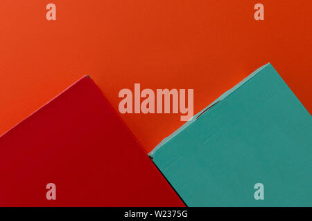 Green and red shoe boxes on orange background Stock Photo