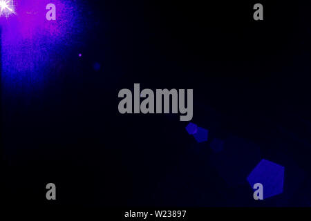 Camera lens flare by laser light create hexagons of objective iris shapes of number depending on number of lens surface and interference effect. Stock Photo