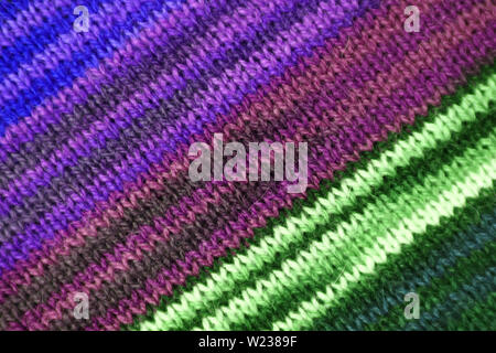Texture of the Diagonal Stripe Patterns of Purple and Green Color Toned Alpaca Knitted Wool Fabric Stock Photo