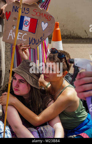 London, UK. 5th July 2019. Extinction Rebellion protest at the French Embassy in solidarity with XR France protesters who were brutally attacked by police during a peaceful protest on a Paris bridge. Police pepper-sprayed the faces of sitting protesters at close range causing burns, pulling sunglasses from one to spray directly into eyes, and injured some by dragging forcefully across the road. Credit: Peter Marshall/Alamy Live News Stock Photo