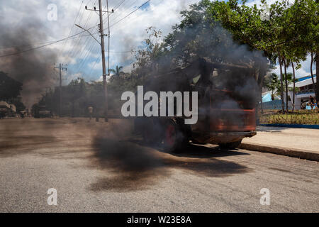 Havana, Cuba - May 29, 2019: Heavy equipment construction machine working in the streets of Havana City, Capital of Cuba, emitting black smoke into th Stock Photo