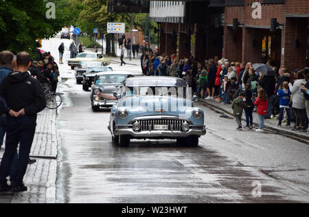 People standing on the side of the street, watching American cars cruising in Västerås city during Summer Meet - one of the biggest carshows in Europe Stock Photo