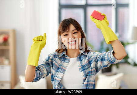 happy asian woman with sponge cleaning at home Stock Photo