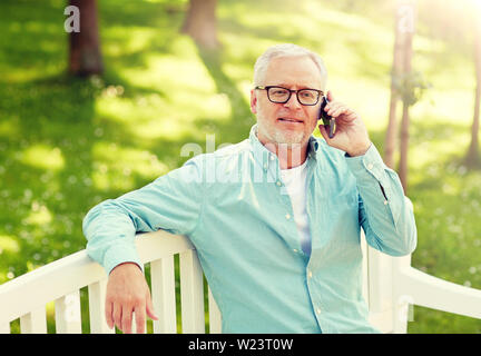 senior man calling on smartphone at summer park Stock Photo
