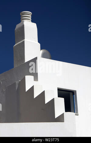 Detail of a white-painted traditional house in Paleochora, S.W.Crete, Greece. Sun and shadows, classic greek house, dark-blue sky. Stock Photo