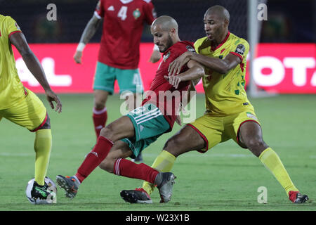 Cairo, Egypt. 05th July, 2019. Morocco's Karim El Ahmadi (L) and Benin's Jordan Adeoti battle for the ball during the 2019 Africa Cup of Nations round of 16 soccer match between Morocco and Benin at Al-Salam Stadium. Credit: Oliver Weiken/dpa/Alamy Live News Stock Photo