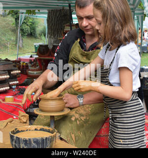 Etara, Bulgaria - September 6, 2018: Open-air pottery workshop for children during the folk festival in Etara Stock Photo