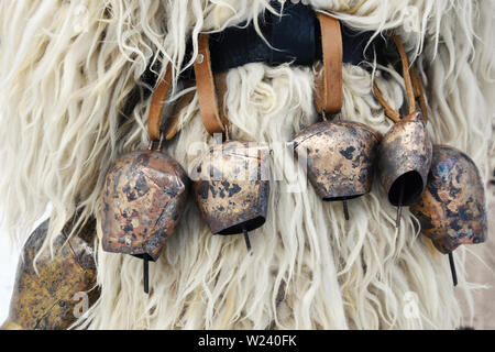 Copper bells on shipskin - close-up detail of typical kuker costume - acknowledged by UNESCO old Bulgarian character - a monster chasing the evil Stock Photo