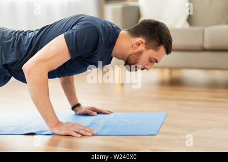 man doing push ups at home Stock Photo