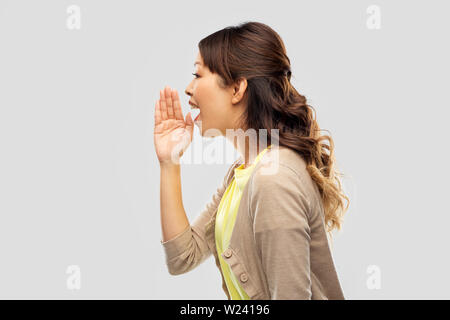 young asian woman calling for someone Stock Photo