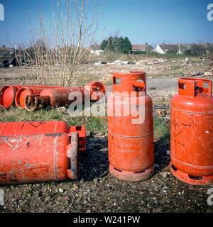 Dumped gas cylinders on urban wasteland near a residential area in Liverpool, UK. Stock Photo