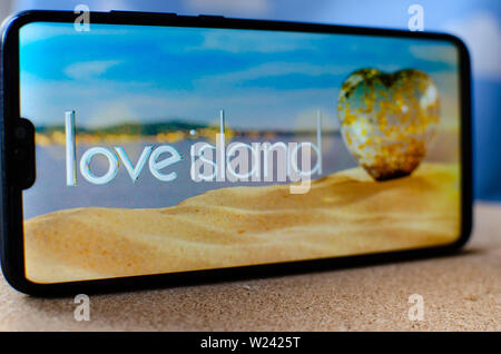 Love Island TV show - logo on the smartphone screen.