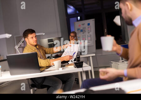 designers or software developers at night office Stock Photo